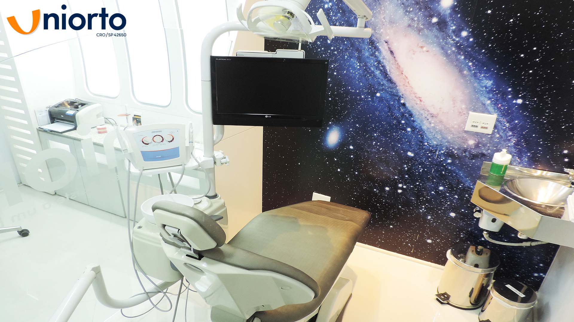 Ambiente interno da Uniorto, com decoração temática de galáxia nas paredes e no teto